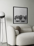 Framed black and white photograph on a wall above a sofa in a modern living room.