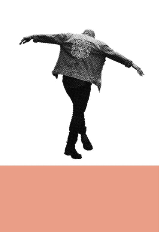 Person wearing a patterned jacket and black pants on a white background with a peach-colored bar at the bottom.