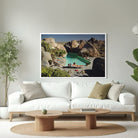 Large whit sofa with a framed image. A woman on the poolside. The Picturalist Slim Aarons Collection. 