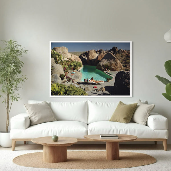 Large whit sofa with a framed image. A woman on the poolside. The Picturalist Slim Aarons Collection. 