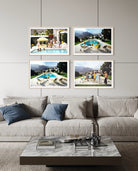 A styled living room scene showing a light beige sofa with blue and beige pillows, a marble coffee table, and four framed photographic prints hanging on the wall above the couch. The prints depict poolside scenes with people and mountains. The Picturalist Wall Art and Photography for Designed Interiors. Slim Aarons Collection, Poolside. Getty Images Gallery. 