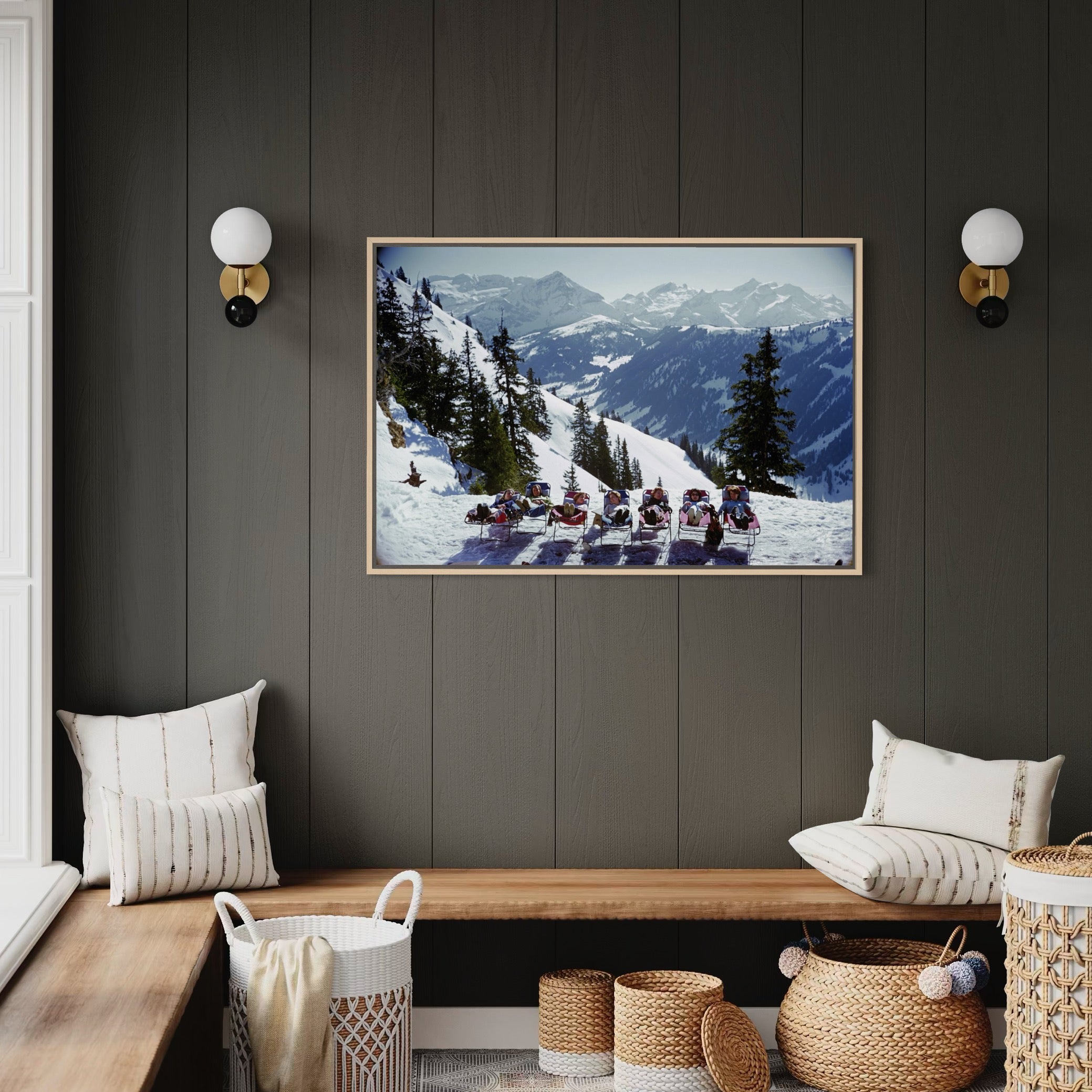 Living room with a mountain landscape painting on a dark wall, wooden bench, and decorative baskets.