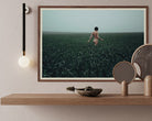Walking in a Meadow by Igor Ustynsky, contemporary fine-art photograph of a solitary figure in a misty green meadow, licensed through Getty Images and custom framed by The Picturalist.