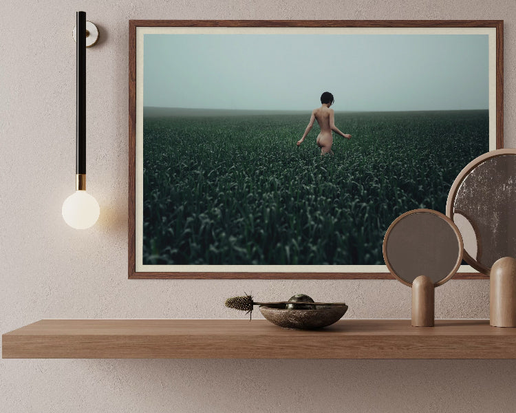 Walking in a Meadow by Igor Ustynsky, contemporary fine-art photograph of a solitary figure in a misty green meadow, licensed through Getty Images and custom framed by The Picturalist.