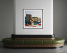 A framed art print depicting a retro scene of a woman by a pool with red bean bags, displayed on a white wall above a modern curved green and wood bench in a gray room.