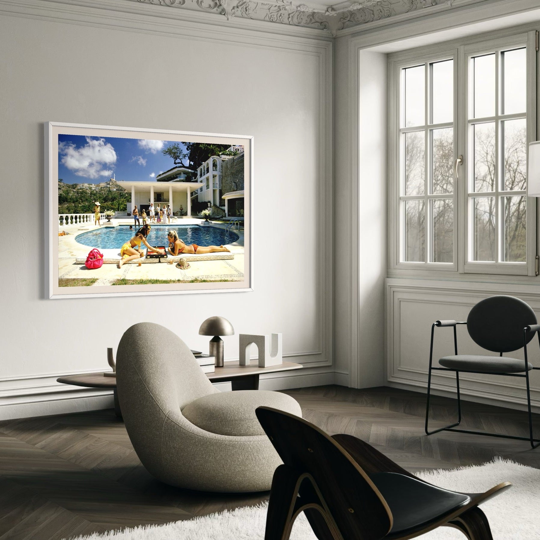 Living room with a large framed picture of a pool scene on the wall.
