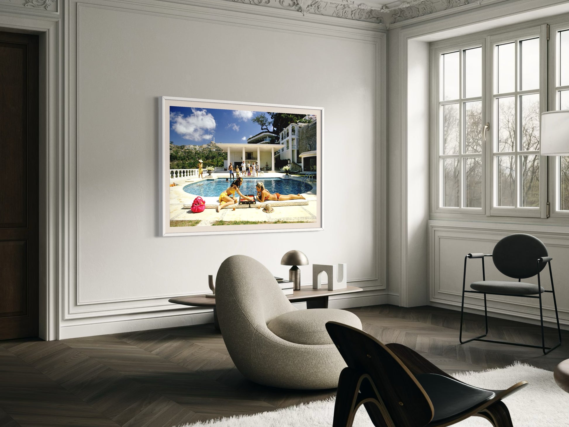 Living room with a large framed picture of a pool scene on the wall.