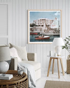 Savioli Spiaggia Hotel, Riccione by Slim Aarons framed above a bed in a refined bedroom, creating a relaxed Italian Riviera atmosphere.