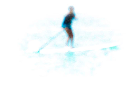 Person water surfing on a blurred background
