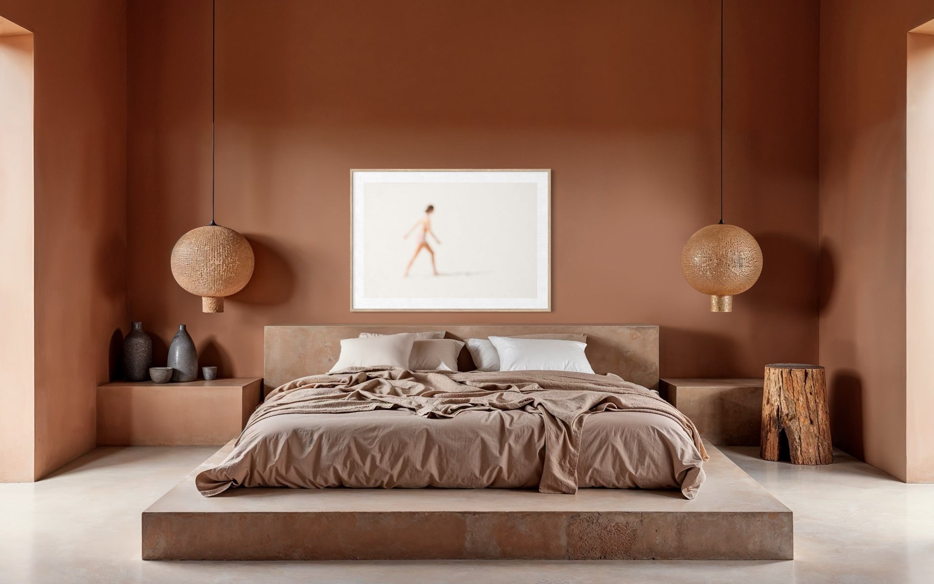 Modern bedroom with a bed, wall art, and decorative items in a warm color palette.