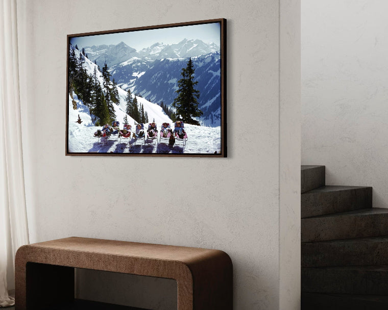 Lounging in Gstaad by Slim Aarons featured in a minimalist hallway gallery wall, ideal for real estate staging art and curated art collections for high-end properties.
