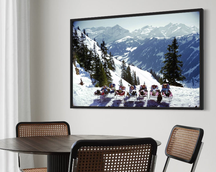 Lounging in Gstaad by Slim Aarons in a refined dining space, enhancing high-end interior design with bespoke art prints and turnkey art solutions.