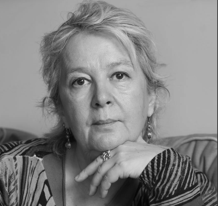 Black and white portrait of a woman with a neutral expression.