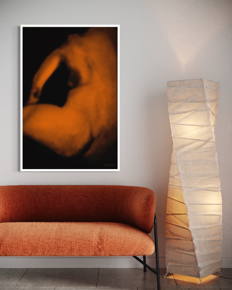 Orange sofa in a room with a framed abstract artwork and a tall floor lamp.