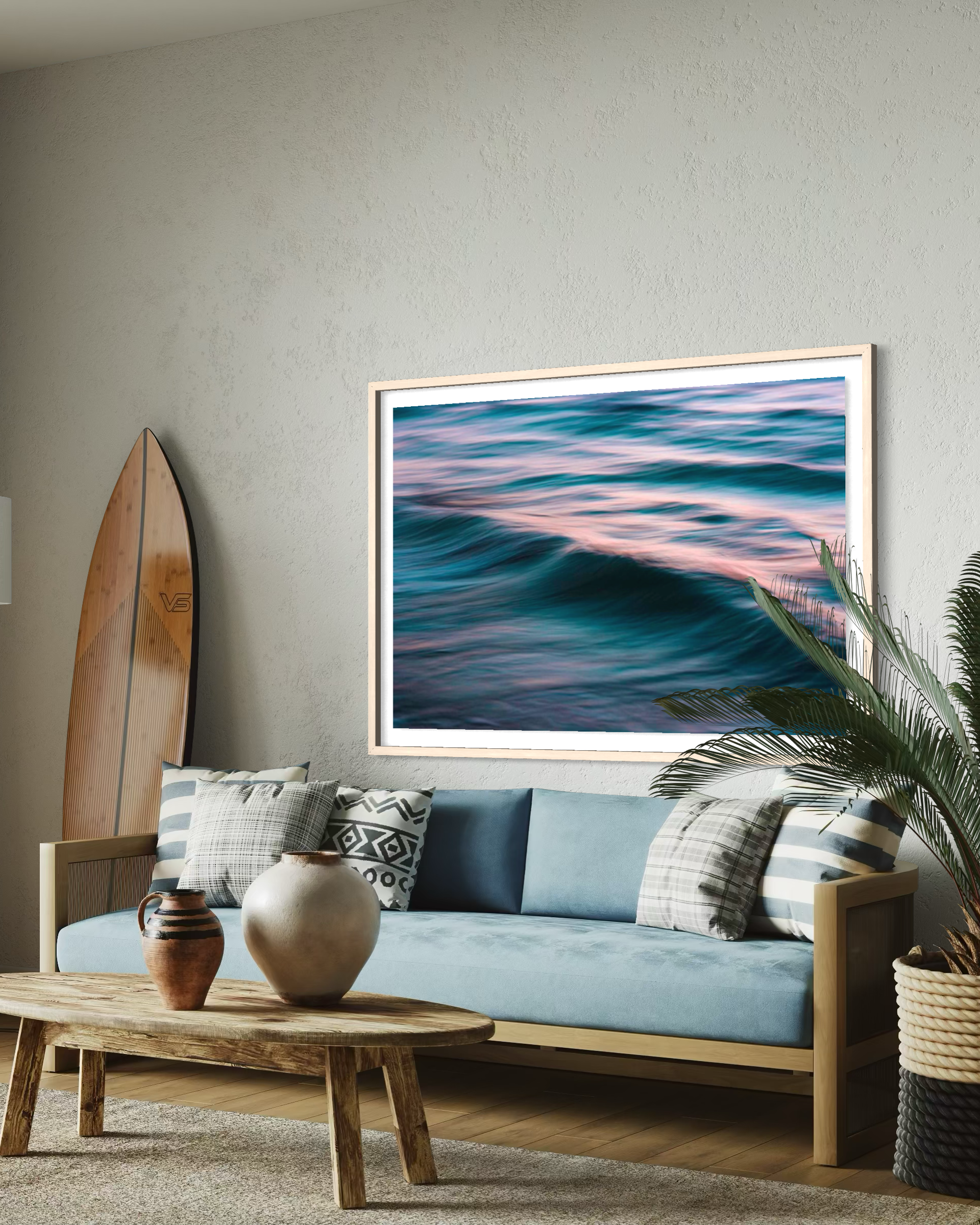 Living room with a blue sofa, wooden coffee table, and framed artwork of wavy colors.