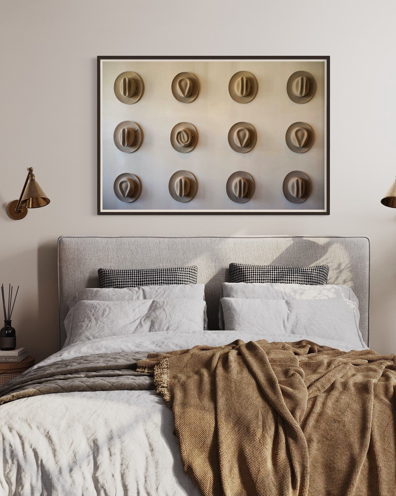 Twelve Hats of the Frontier shown above a bedroom setting, framed Modern Americana artwork curated by The Picturalist.