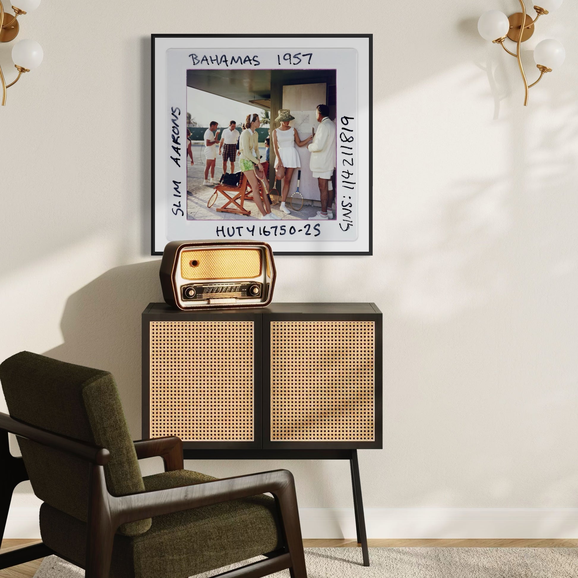Vintage-style radio on a cabinet with a framed photo above in a room with a chair and wall decor.