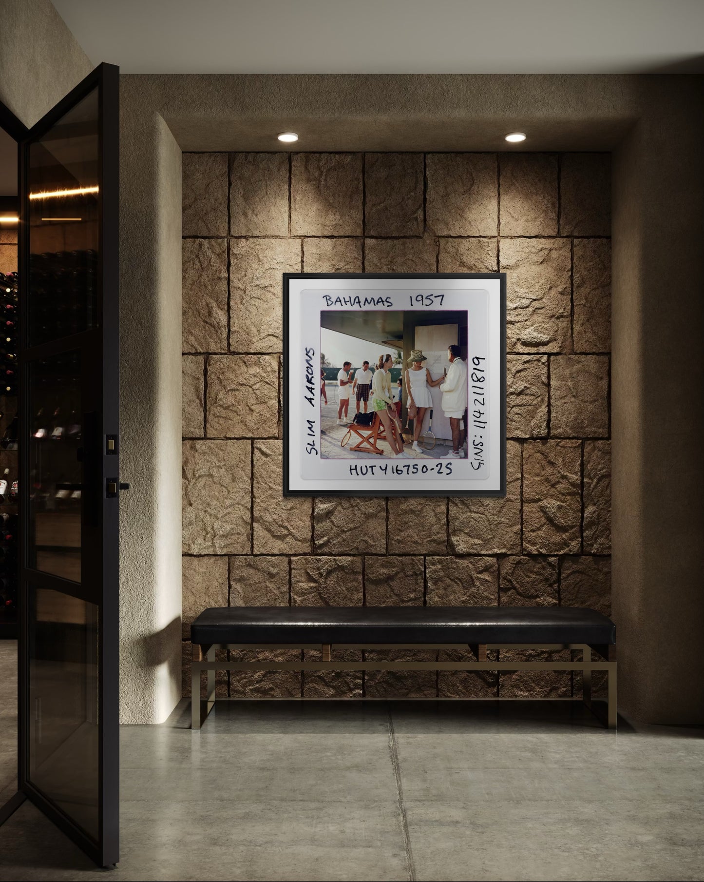 Framed photograph on a stone wall with a bench below