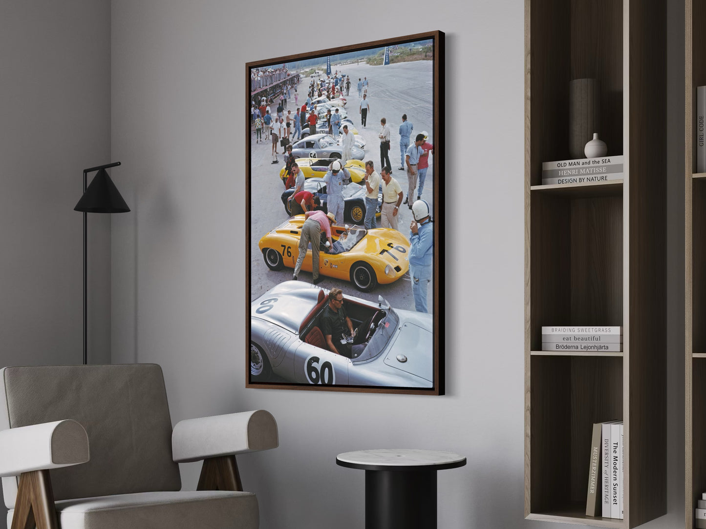 Framed artwork of a race car scene on a wall in a room with furniture.