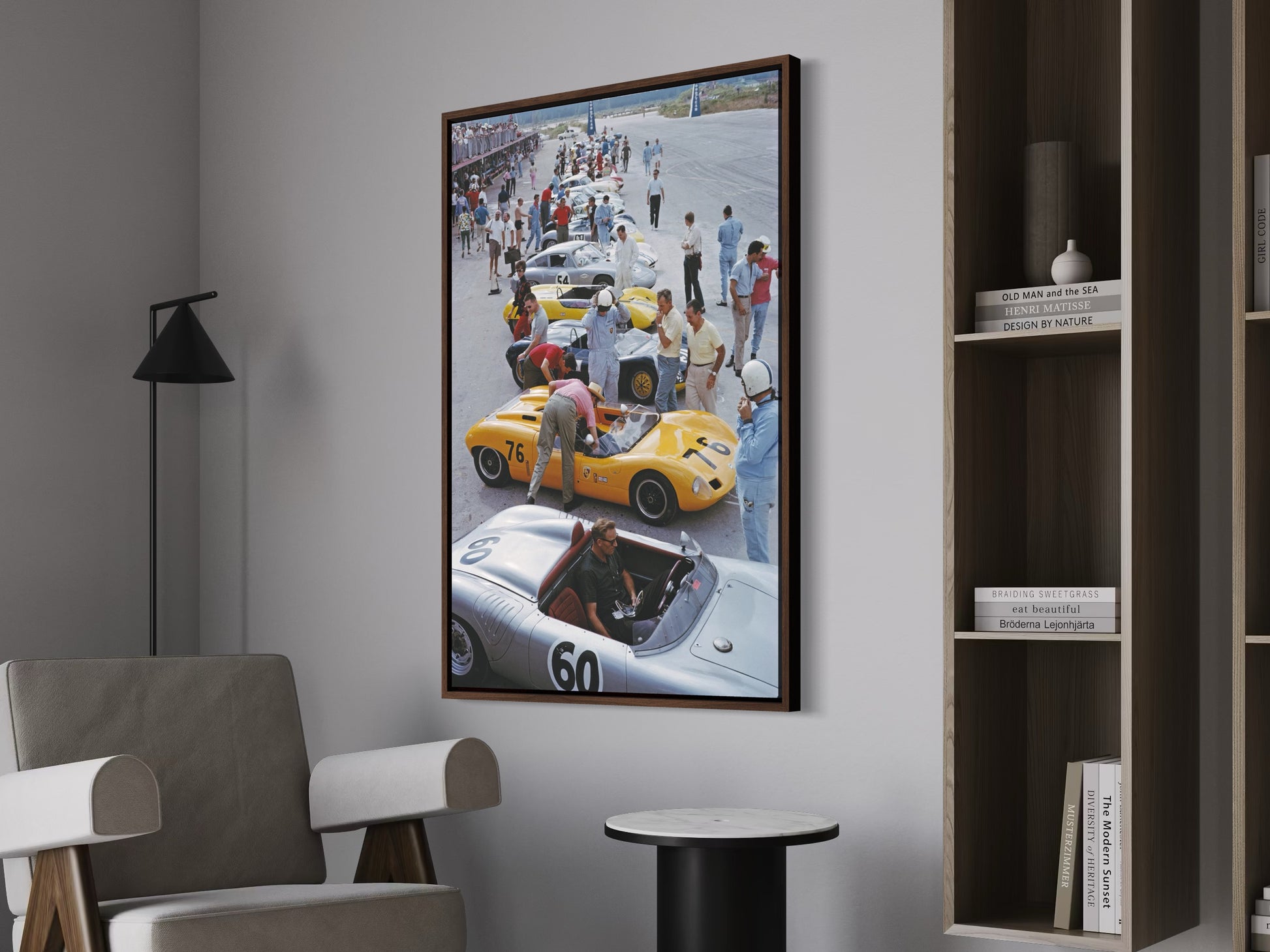 Framed artwork of a race car scene on a wall in a room with furniture.