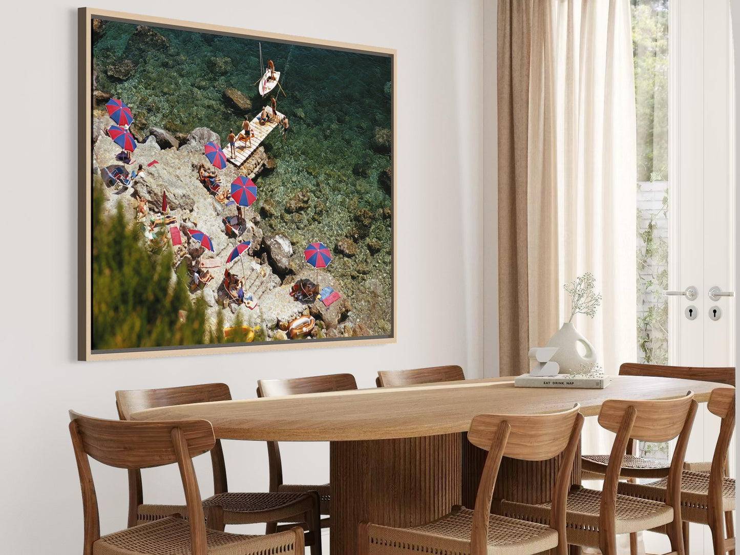 Dining room with a large framed artwork on the wall above a wooden table and chairs.