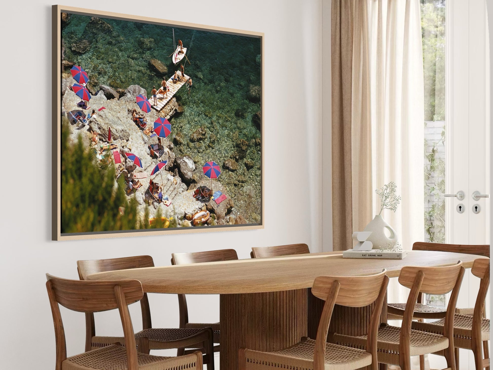 Dining room with a large framed artwork on the wall above a wooden table and chairs.