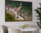 Framed artwork of a beach scene with people and umbrellas above a dining table.