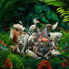 A whimsical black and white photograph featuring a variety of animals gathered close together in a lush green forest setting.