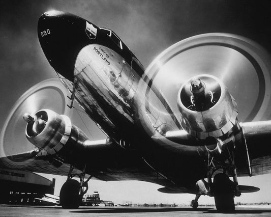 Vintage airplane on a runway with a clear sky background