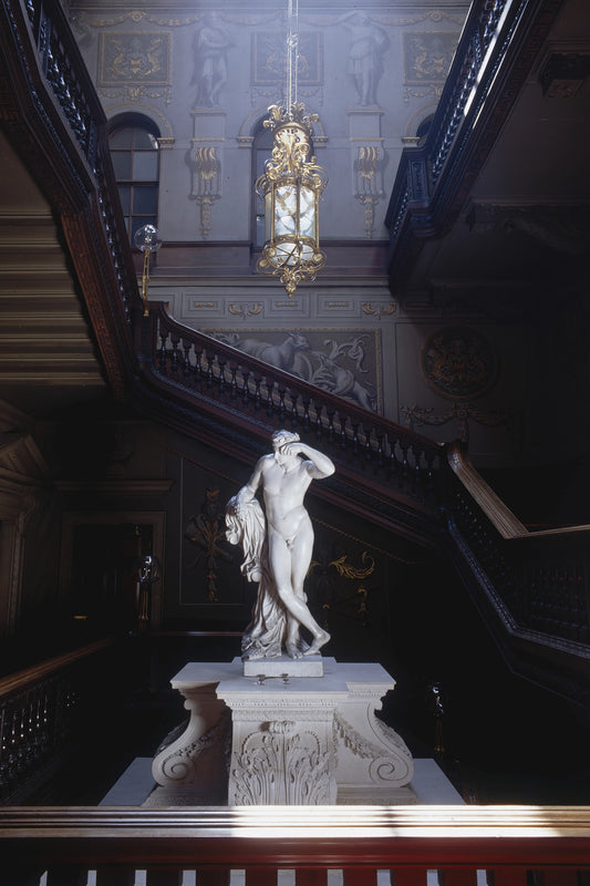 Statue in a grand interior setting with intricate details