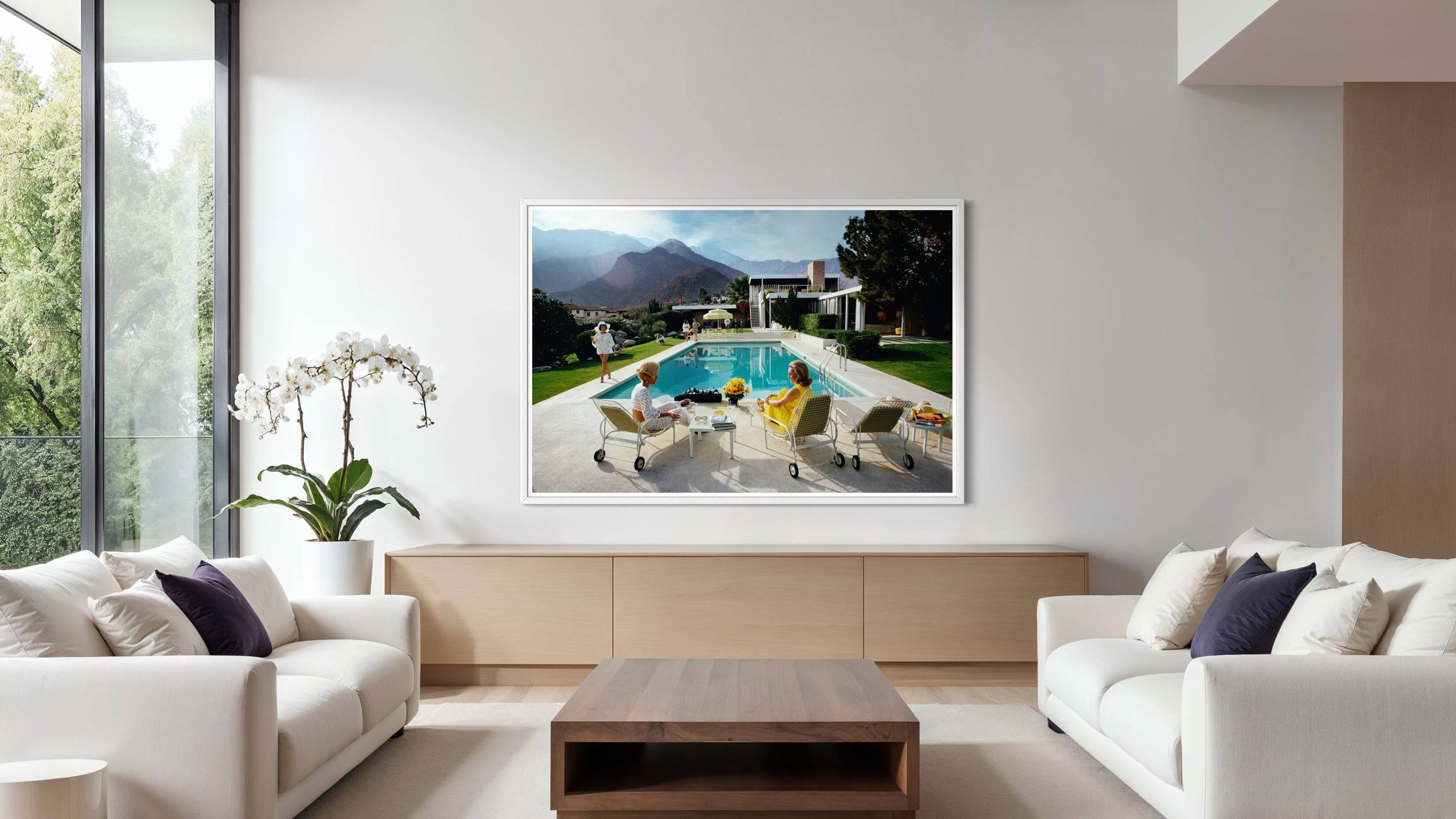 Modern living room with a large framed picture of a pool scene on the wall.