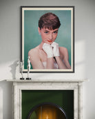 Framed portrait of a woman on a fireplace mantle with decorative items.