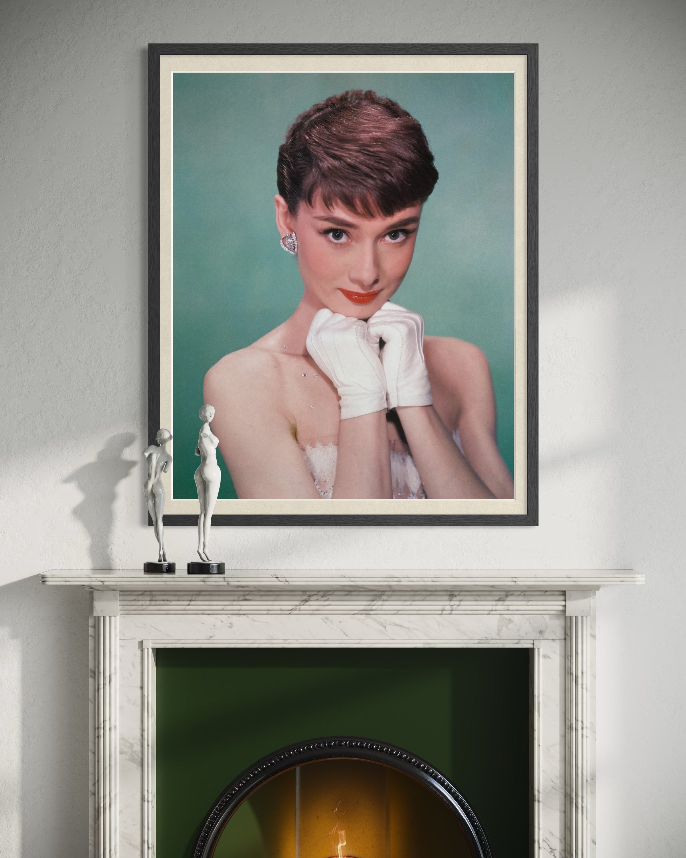 Framed portrait of a woman on a fireplace mantle with decorative items.