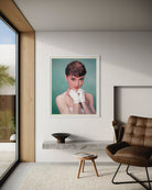 Framed portrait of a woman in a modern living room with a brown chair and glass door.