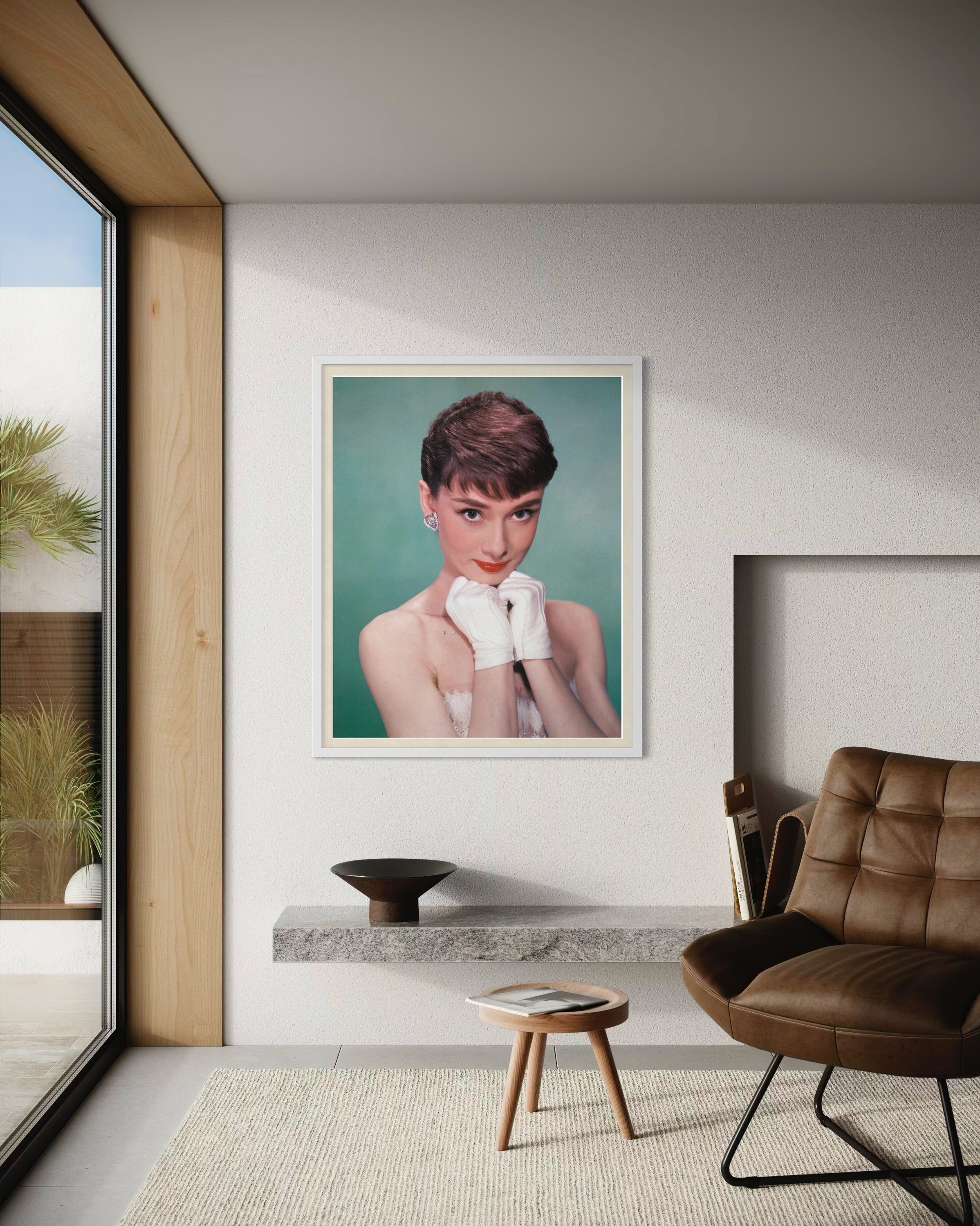 Framed portrait of a woman in a modern living room with a brown chair and glass door.