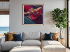 Modern living room with a gray sectional sofa, decorative pillows, and a framed artwork of a woman in a red dress.