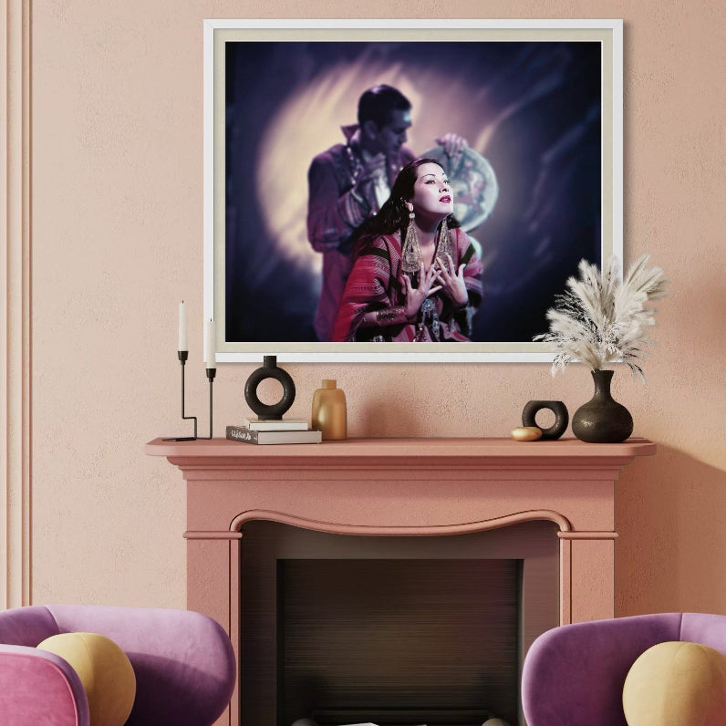 Living room with pink walls, purple armchairs, and a framed artwork above a fireplace.