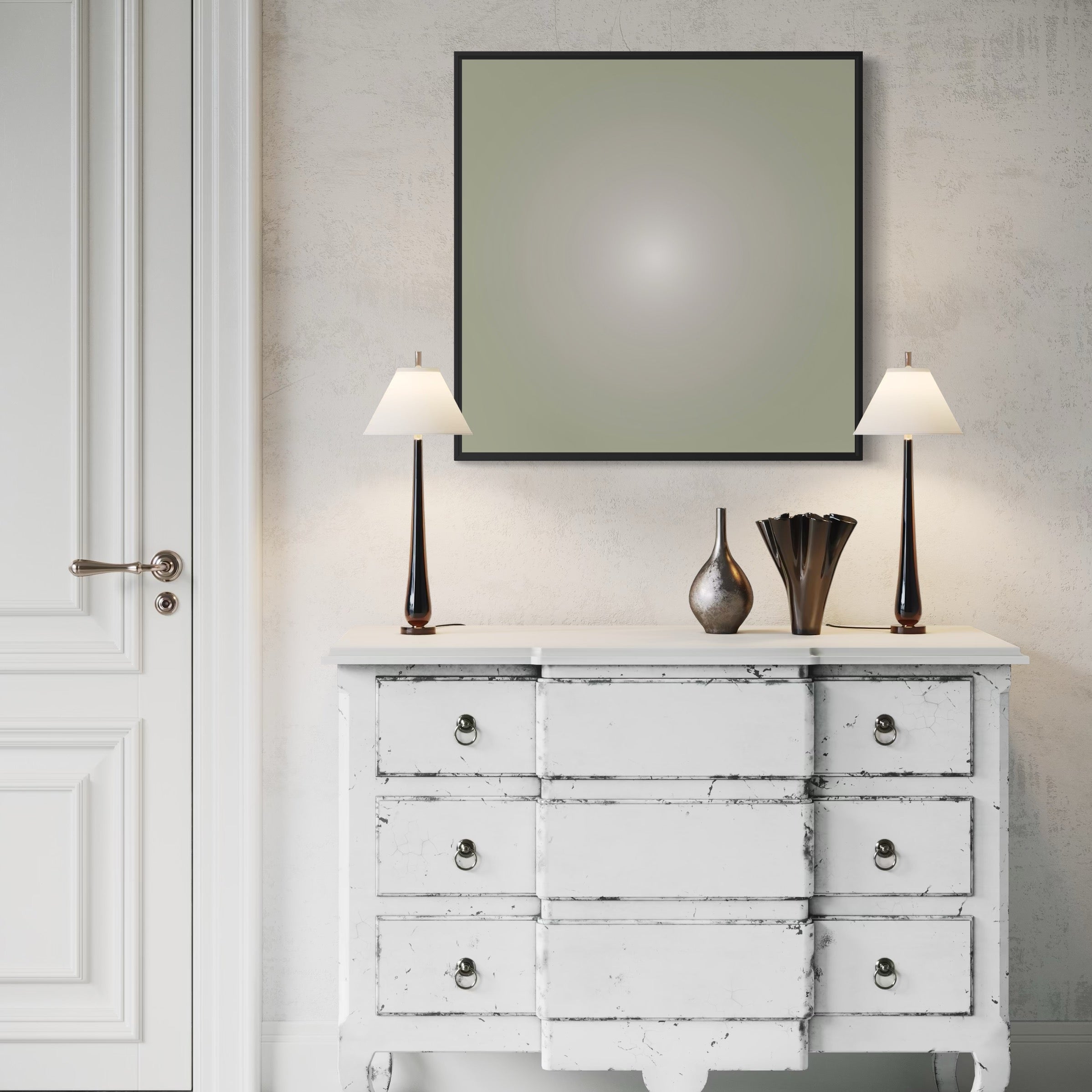White distressed dresser with two lamps and decorative vases against a neutral wall.