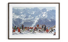 A framed photographic print of a snowy mountain landscape with people sitting in red and green beach chairs in the foreground, shown against a white background.