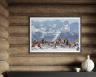 A framed art print depicting a snowy mountain scene with skiers and snowboarders, mounted on a rustic wooden log wall above a shelf with decorative items.