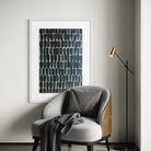 Modern interior with a gray armchair, abstract art, and standing lamp.