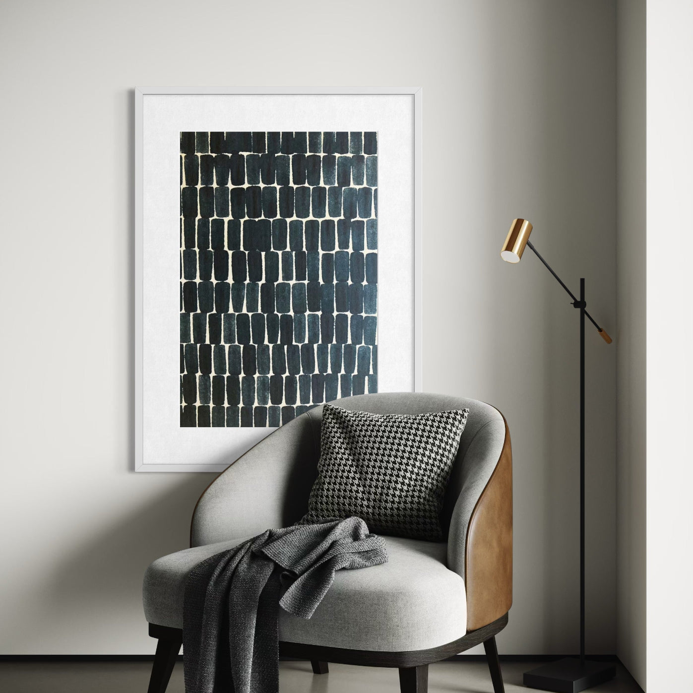 Modern interior with a gray armchair, abstract art, and standing lamp.