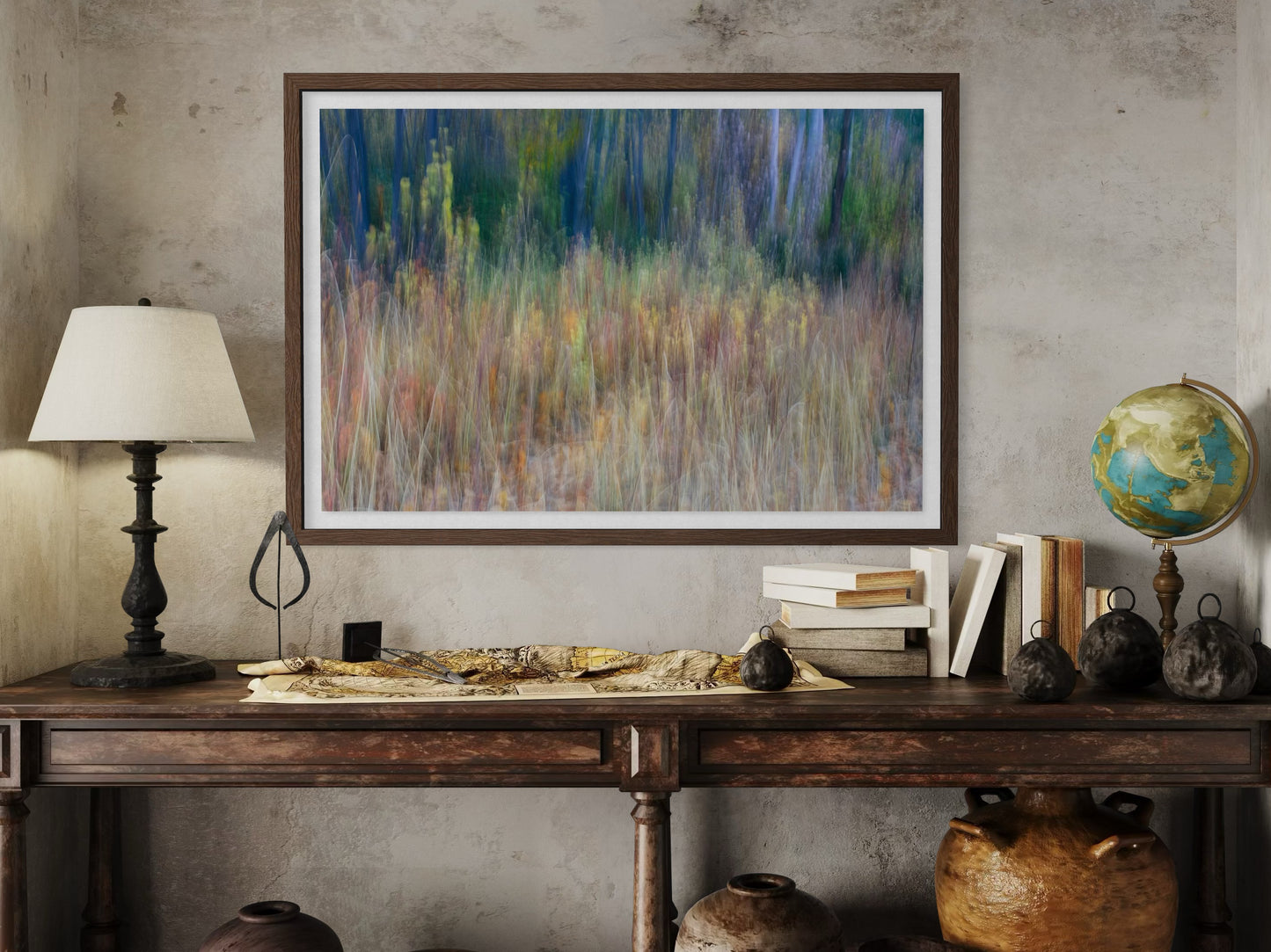 Framed abstract painting on a wall above an antiquewoode n desk with decorative items.