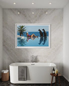 A framed art print depicting a woman lounging by an infinity pool with two dogs, displayed on a textured gray stone wall above a white freestanding bathtub in a modern bathroom setting.