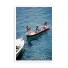Illustrative matte-white floater-framed preview, without added mat, of Riva in Porto Ercole by Slim Aarons. Proportions vary by size.