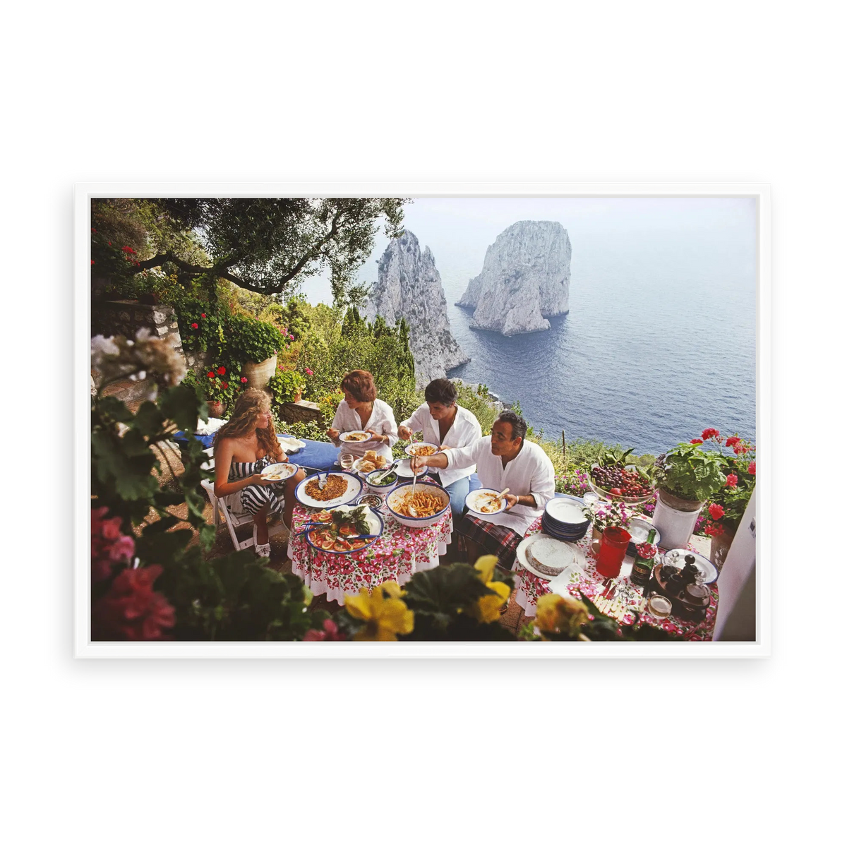 Illustrative matte-white floater-framed preview, without added mat, of Dining Al Fresco on Capri by Slim Aarons. Proportions vary by size.