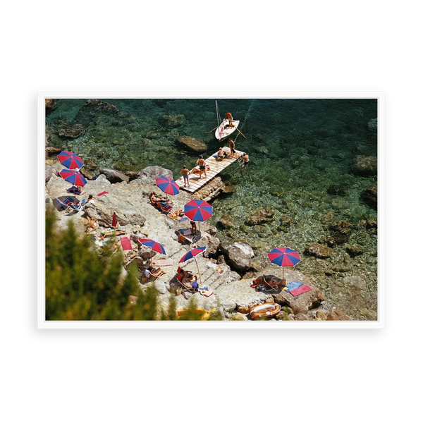 Illustrative matte-white floater-framed preview, without added mat, of Beach at Il Pellicano by Slim Aarons. Proportions vary by size.