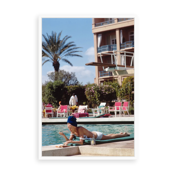 Illustrative matte-white floater-framed preview, without added mat, of Poolside in Marrakesh Morocco by Slim Aarons. Proportions vary by size.