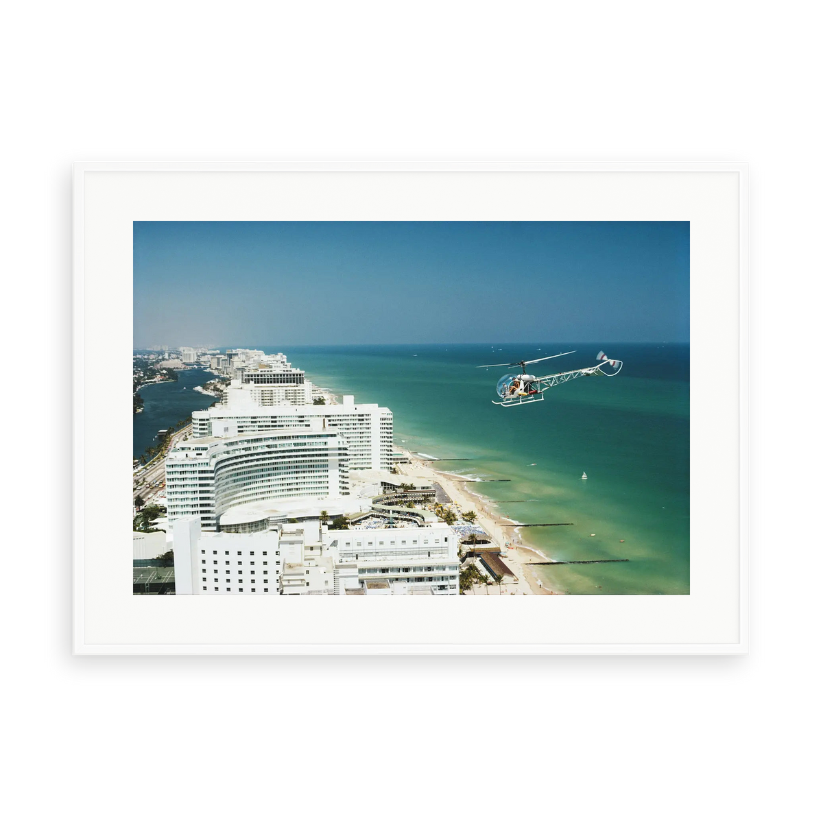 Illustrative matte-white framed preview with white inner border of Aerial Miami Beach by Slim Aarons. Proportions vary by size.