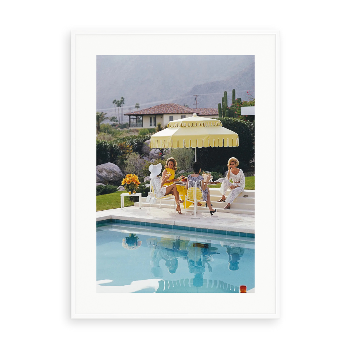 Illustrative matte-white framed preview with white inner border of Nelda and Friends by Slim Aarons. Proportions vary by size.
